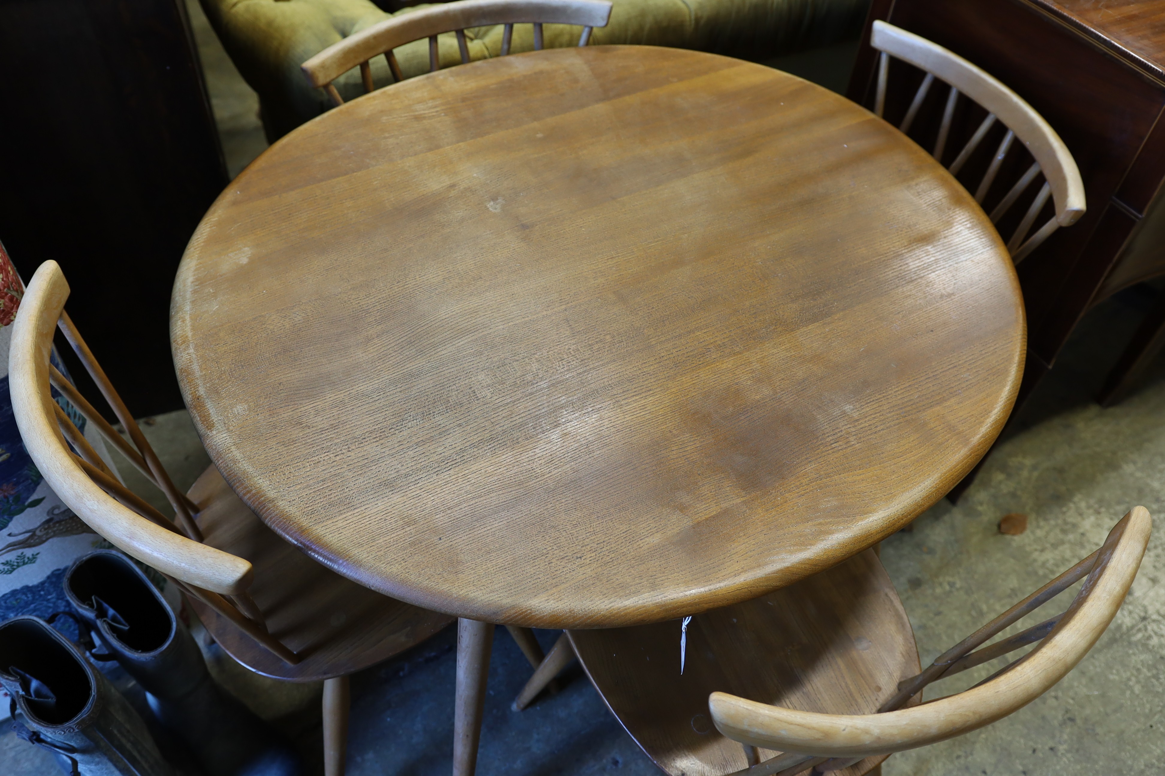 An Ercol elm and beech oval dining table, width 99cm, depth 89cm, height 71cm and four Chiltern chairs